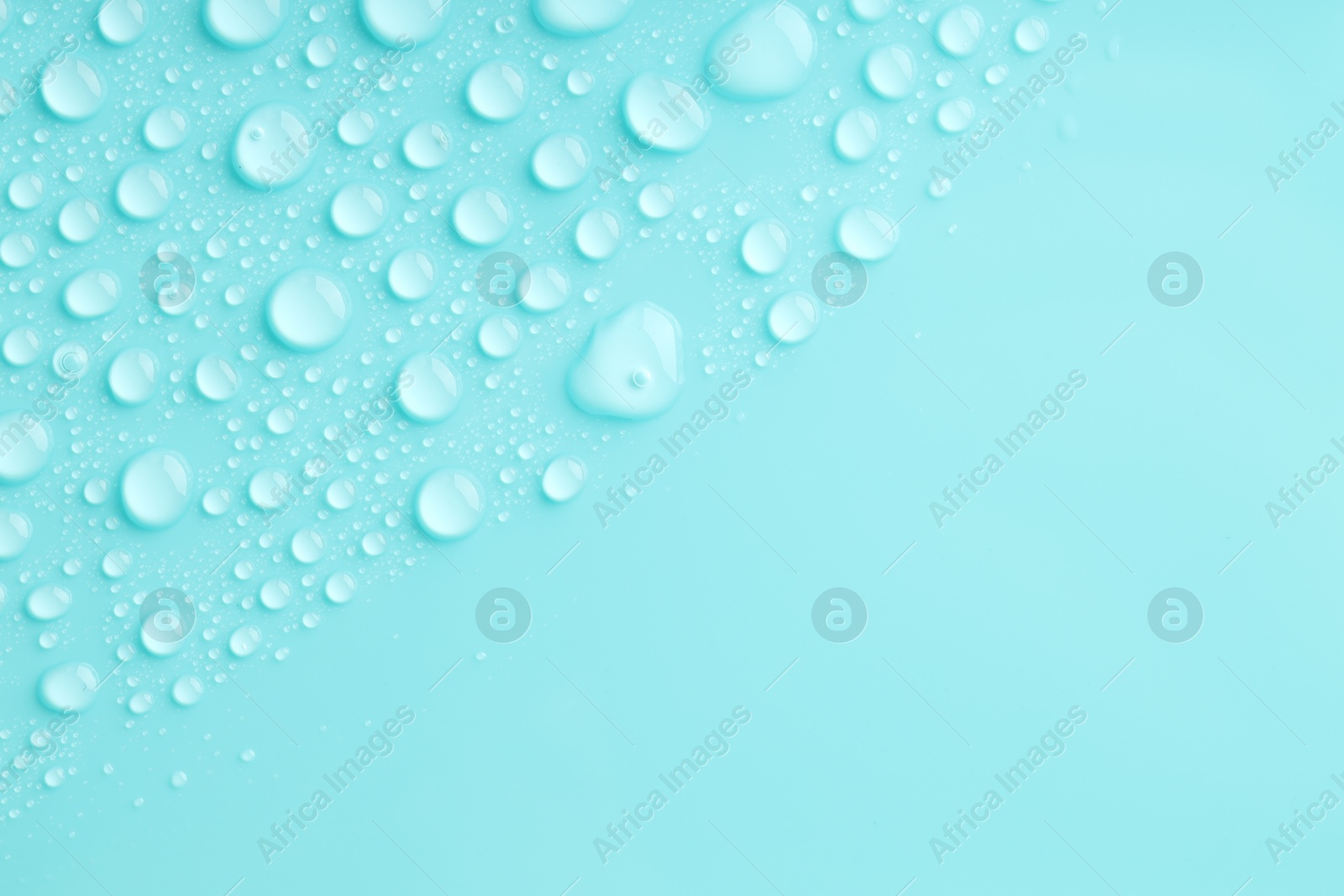 Photo of Water drops on turquoise background, top view. Space for text