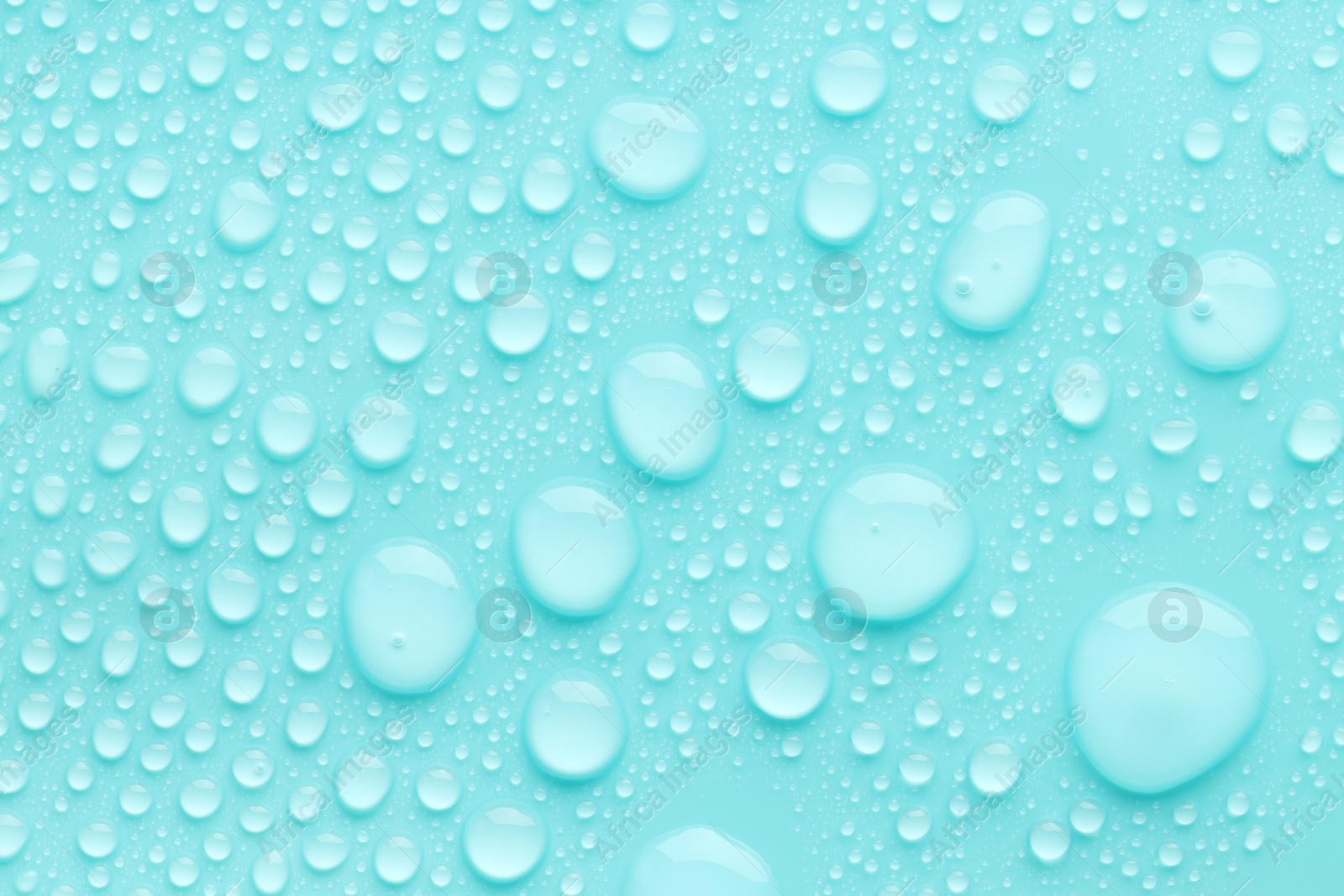 Photo of Water drops on turquoise background, top view