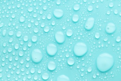 Photo of Water drops on turquoise background, top view