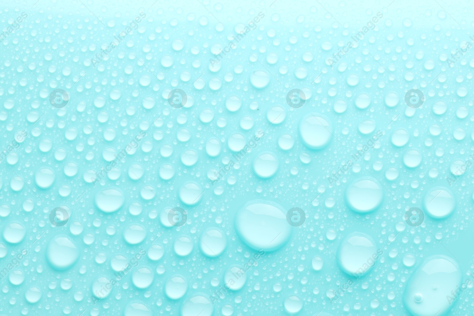 Photo of Water drops on turquoise background, top view