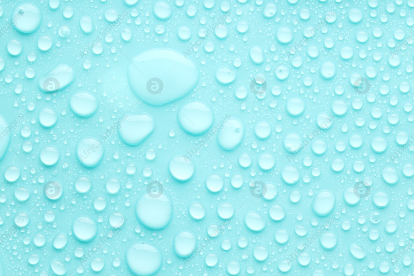 Photo of Water drops on turquoise background, top view