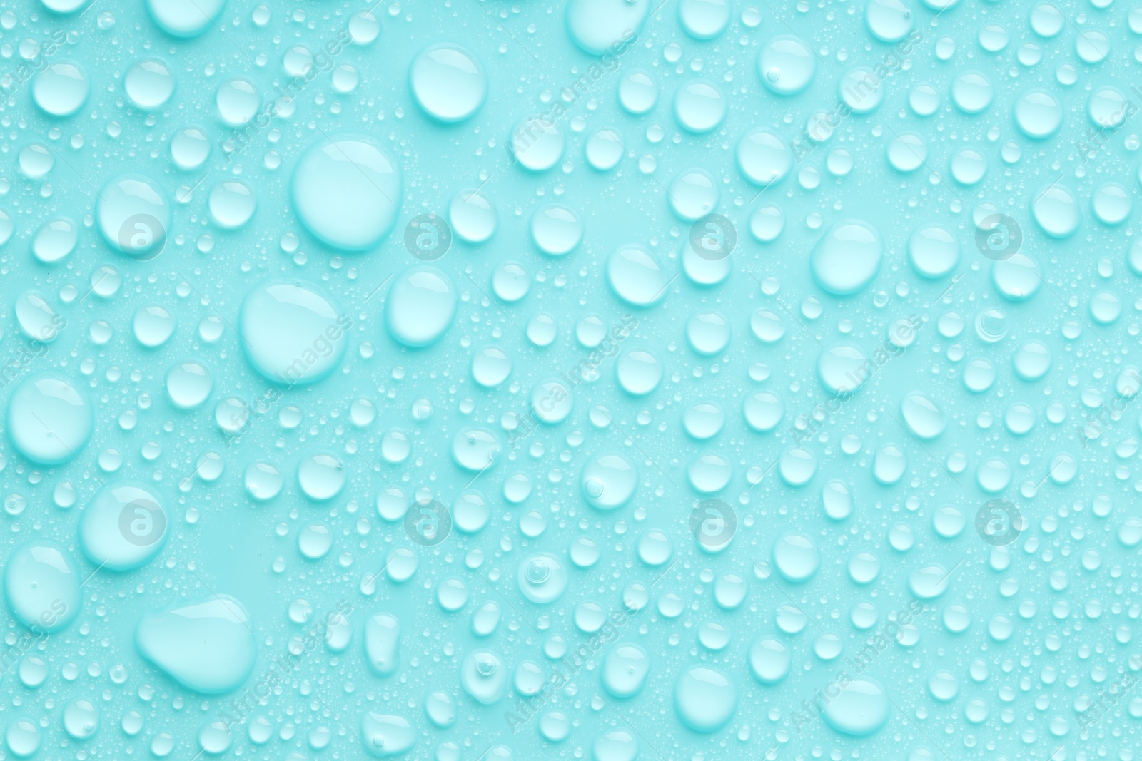 Photo of Water drops on turquoise background, top view