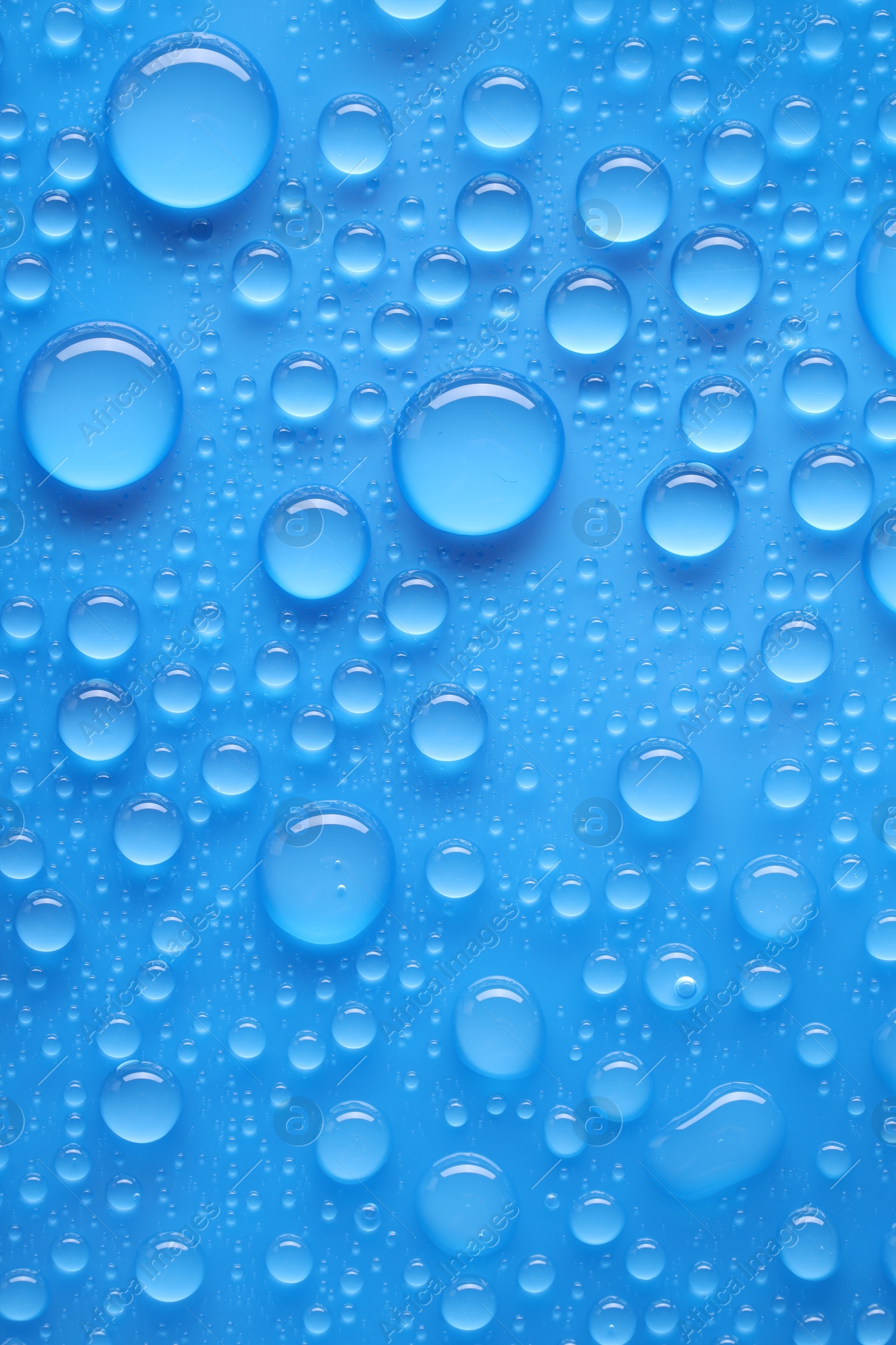 Photo of Water drops on blue background, top view