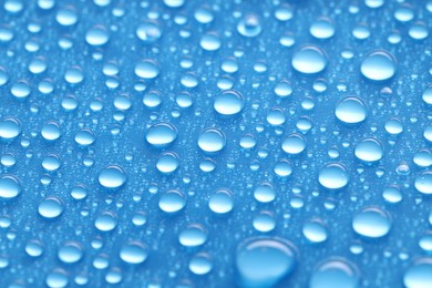 Photo of Water drops on blue background, top view