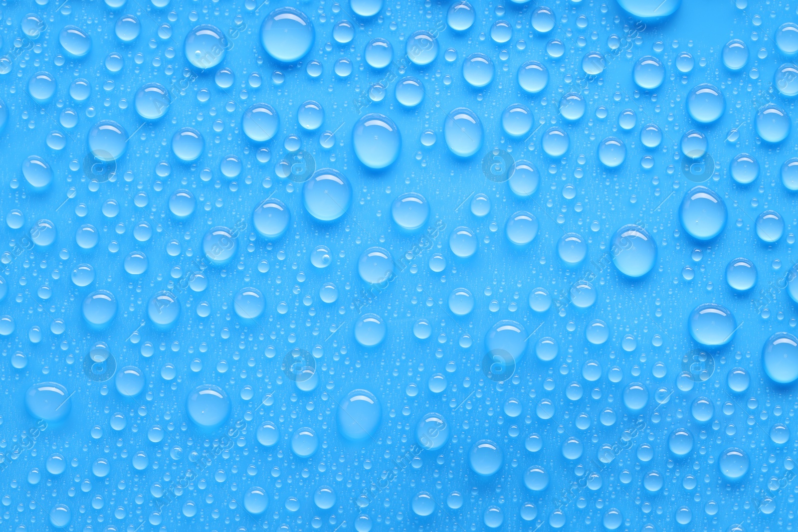 Photo of Water drops on blue background, top view