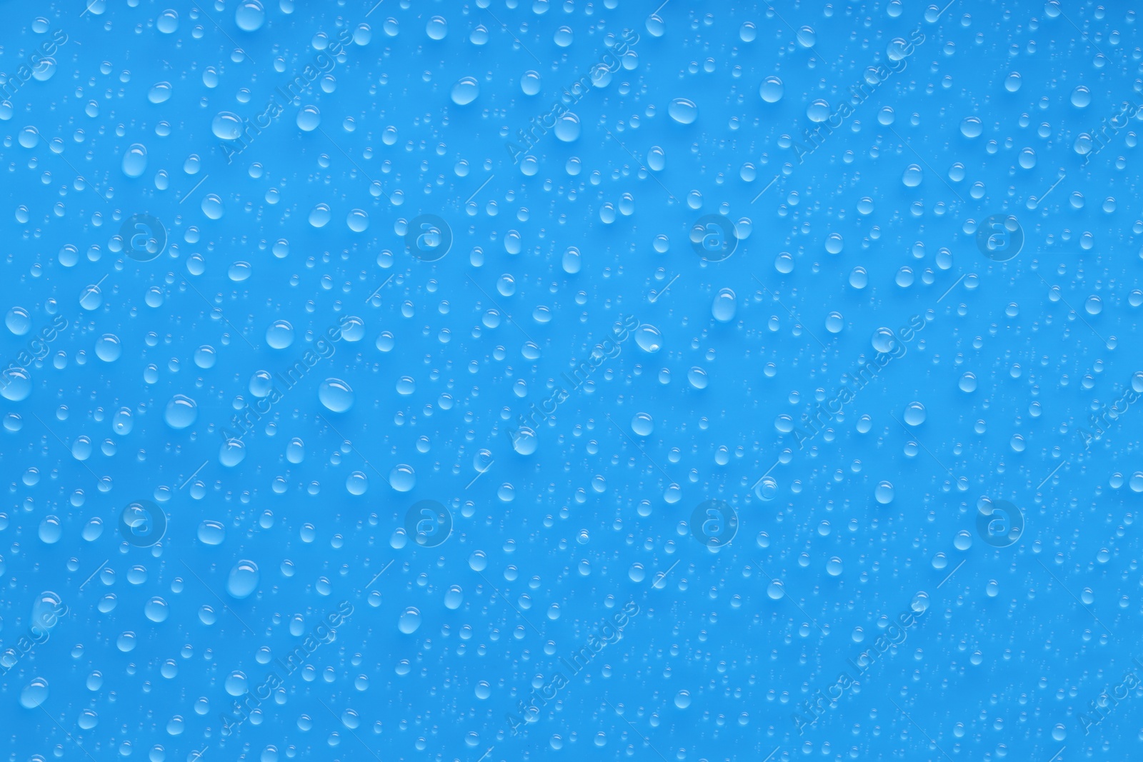 Photo of Water drops on blue background, top view