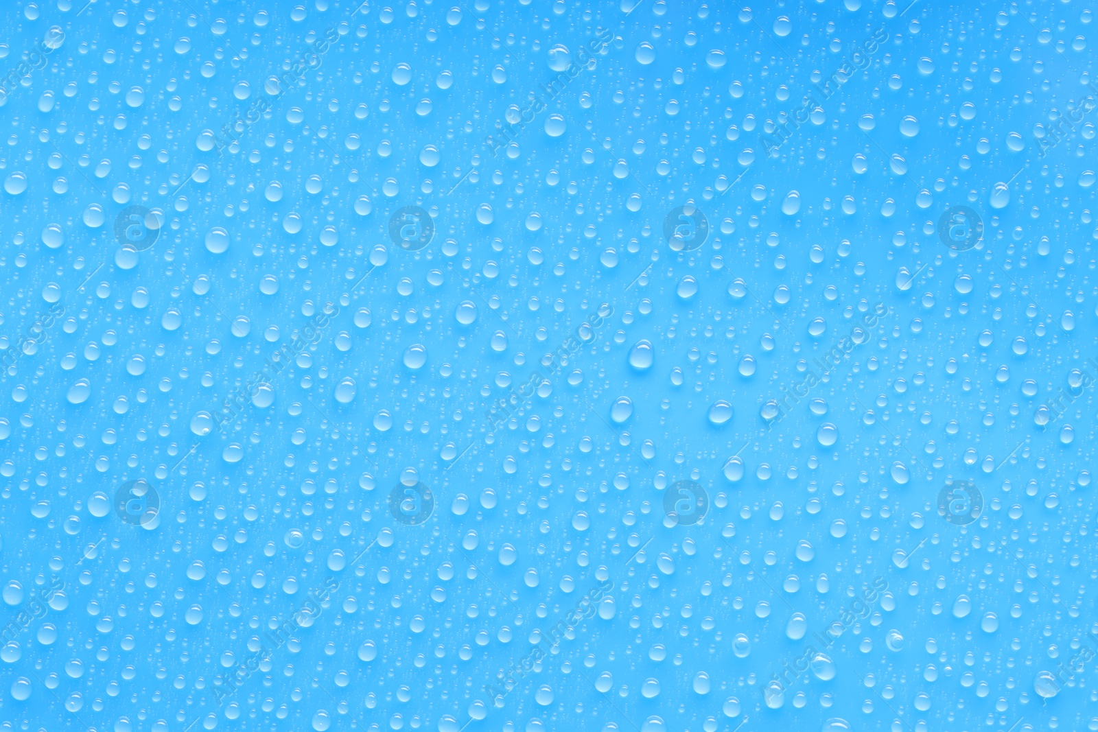 Photo of Water drops on blue background, top view