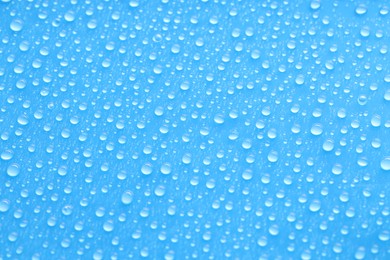 Photo of Water drops on blue background, top view