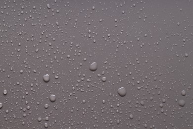 Photo of Water drops on gray background, top view