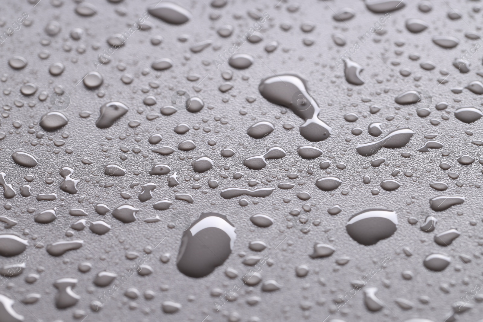 Photo of Water drops on gray background, closeup view