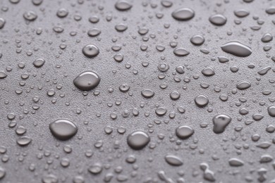 Photo of Water drops on gray background, closeup view