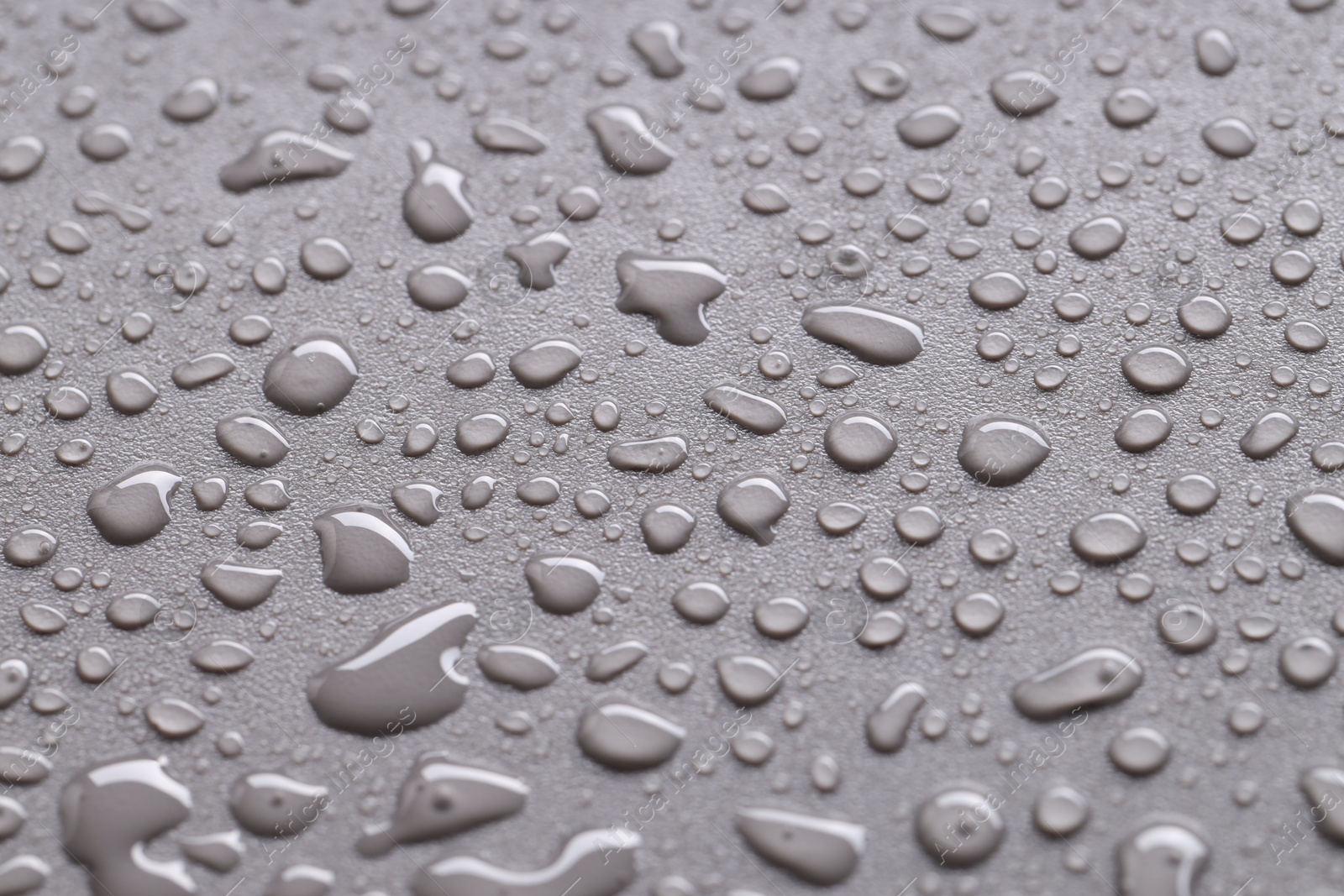 Photo of Water drops on gray background, closeup view