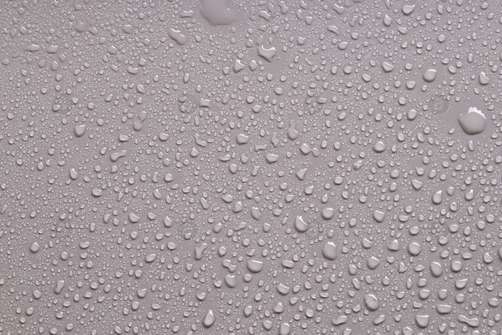 Photo of Water drops on gray background, top view