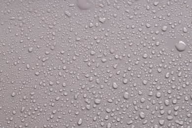 Photo of Water drops on gray background, top view