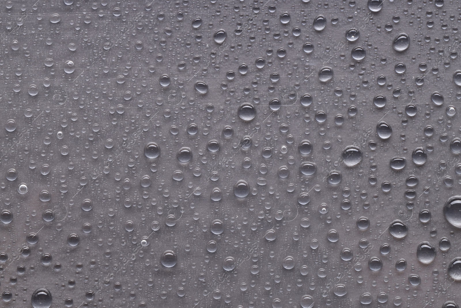 Photo of Water drops on gray background, top view