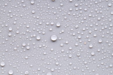 Photo of Water drops on light gray background, top view