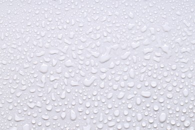 Photo of Water drops on light gray background, top view