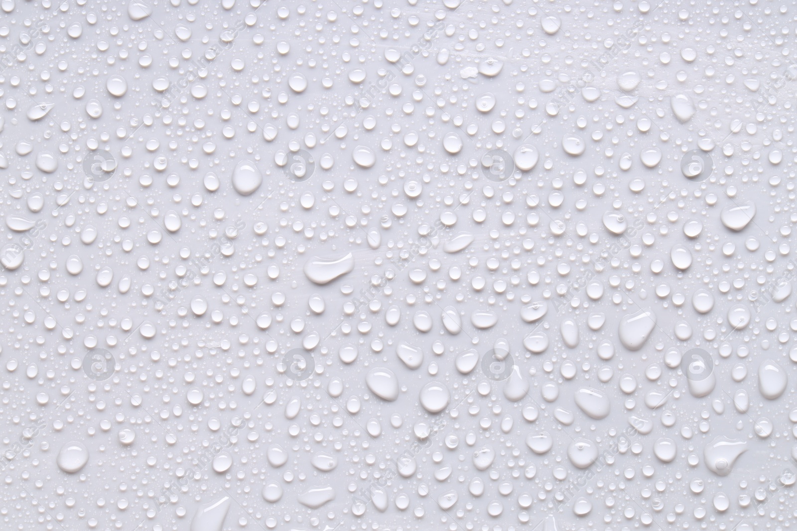 Photo of Water drops on light gray background, top view