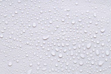 Photo of Water drops on light gray background, top view