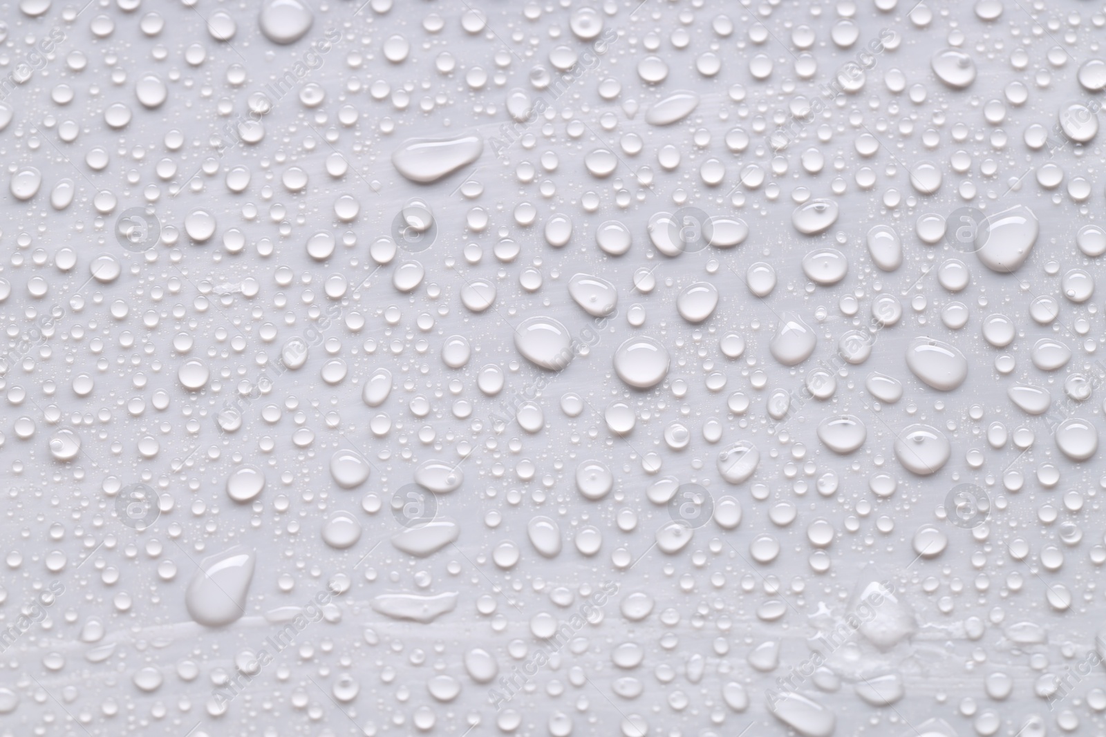 Photo of Water drops on light gray background, top view