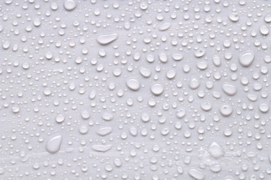 Photo of Water drops on light gray background, top view