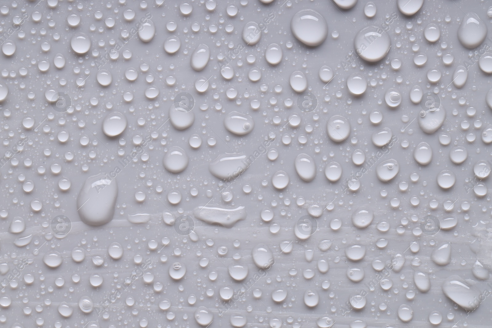 Photo of Water drops on gray background, top view