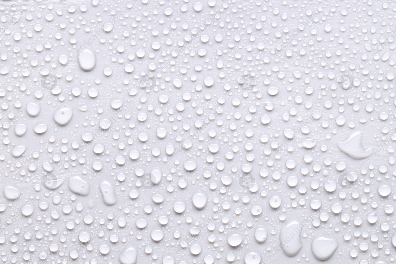 Photo of Water drops on light gray background, top view