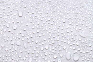 Photo of Water drops on light gray background, top view