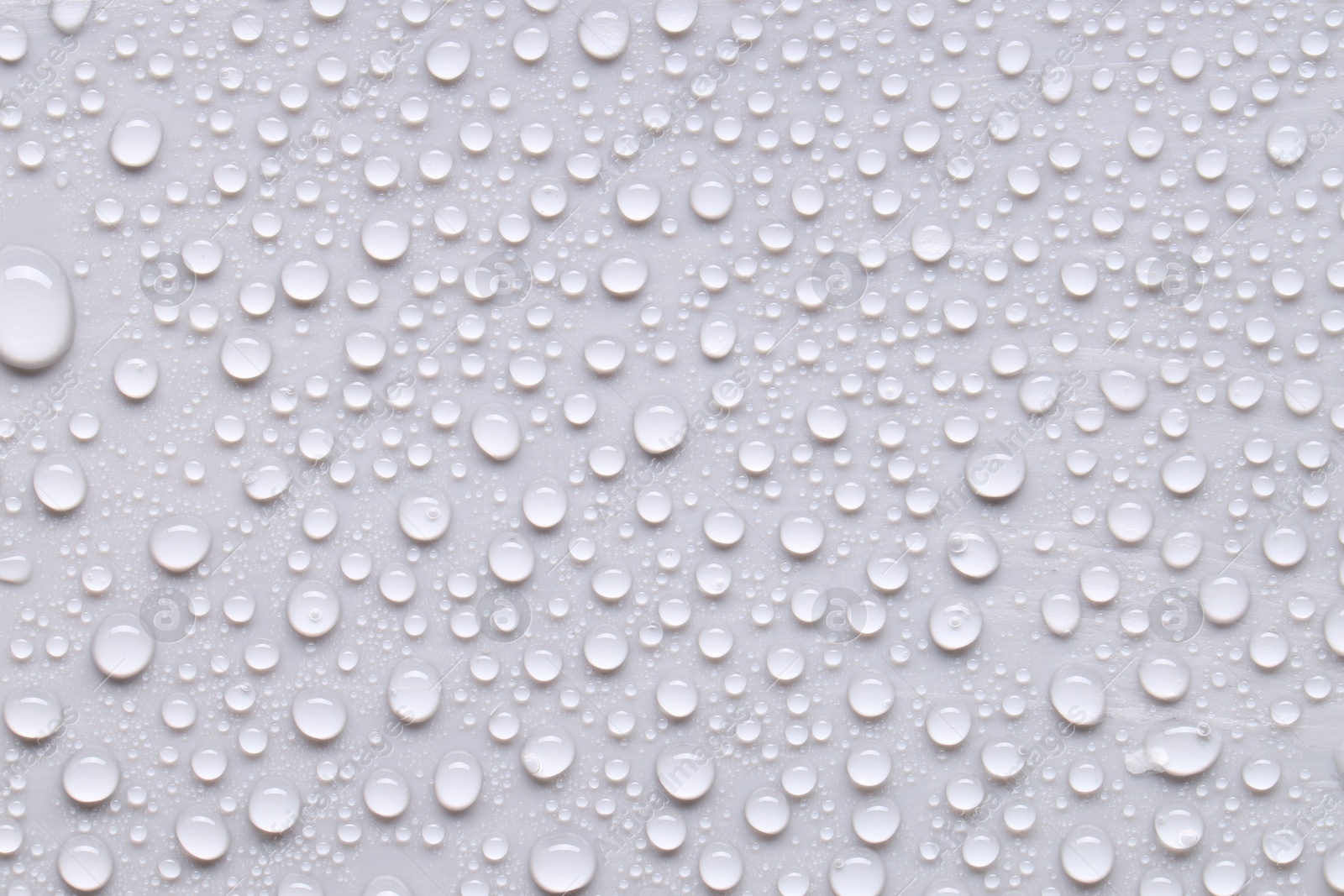 Photo of Water drops on light gray background, top view