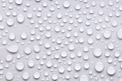 Photo of Water drops on light gray background, top view