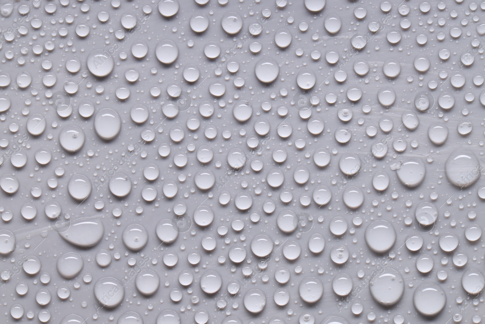 Photo of Water drops on gray background, top view