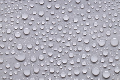 Photo of Water drops on gray background, top view