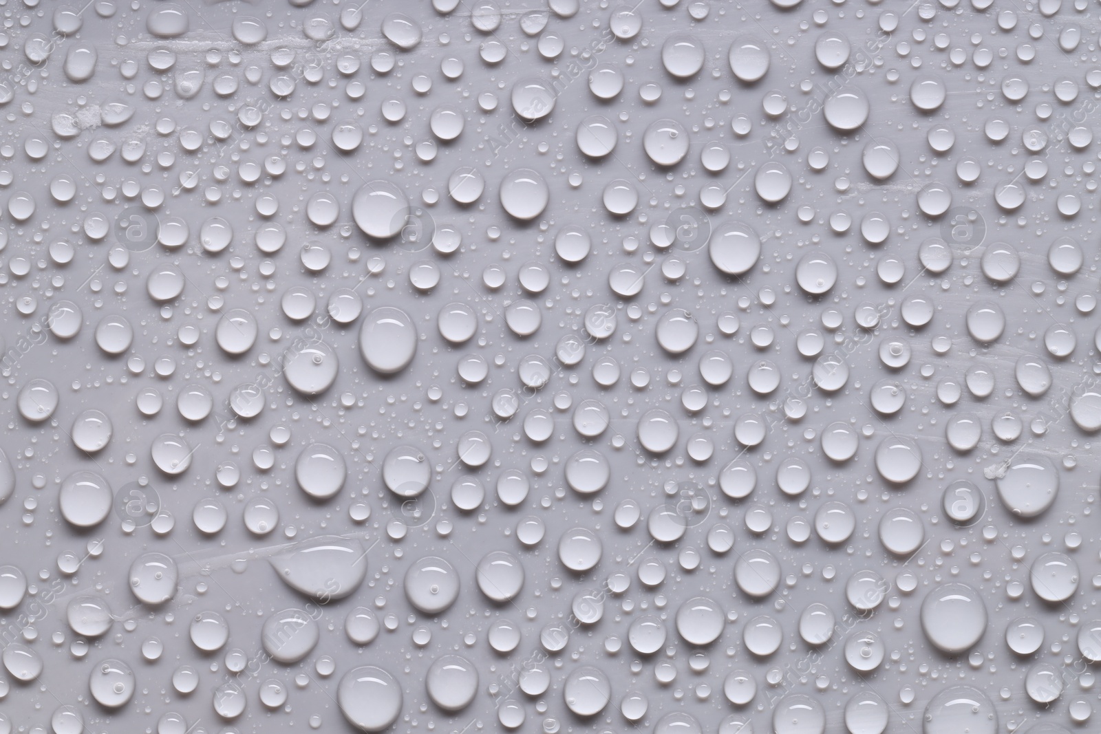 Photo of Water drops on gray background, top view