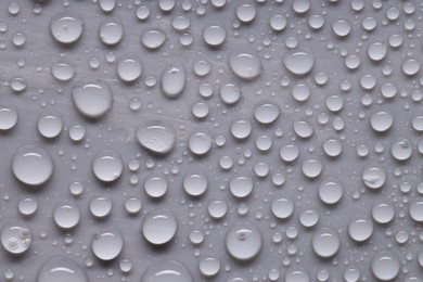 Photo of Water drops on gray background, top view