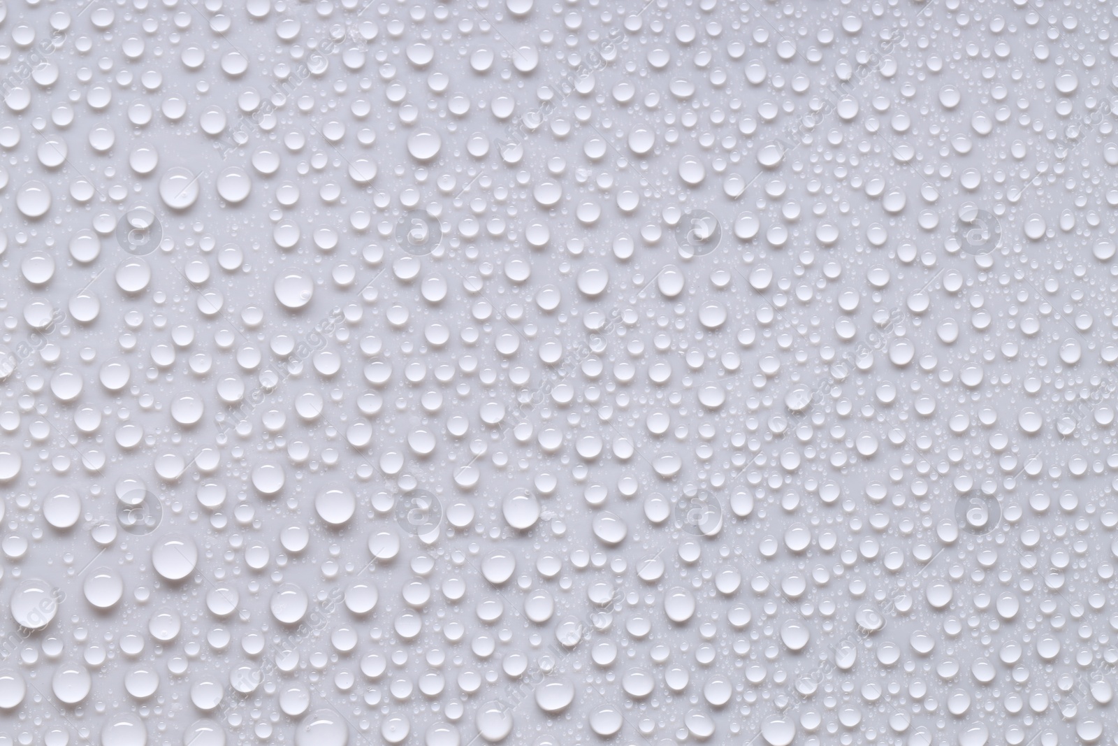 Photo of Water drops on light gray background, top view