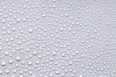 Photo of Water drops on light gray background, top view