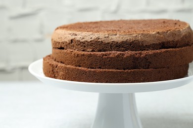 Photo of Cut chocolate sponge cake on light table