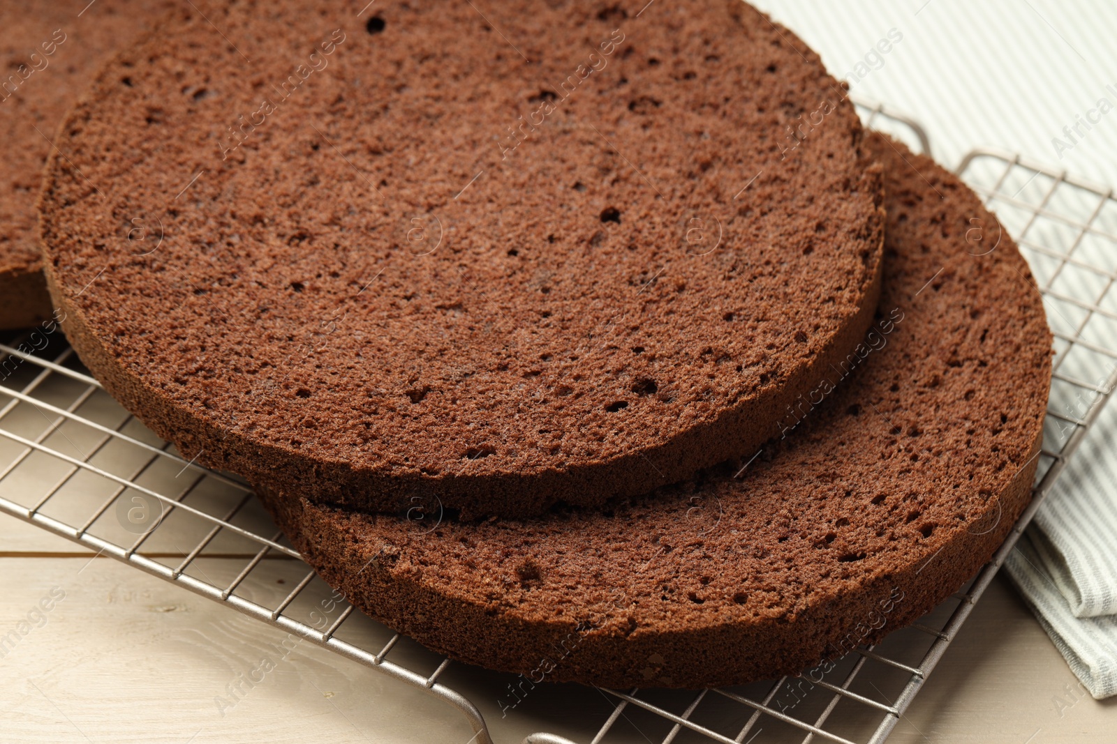 Photo of Cut tasty chocolate sponge cake on wooden table, closeup