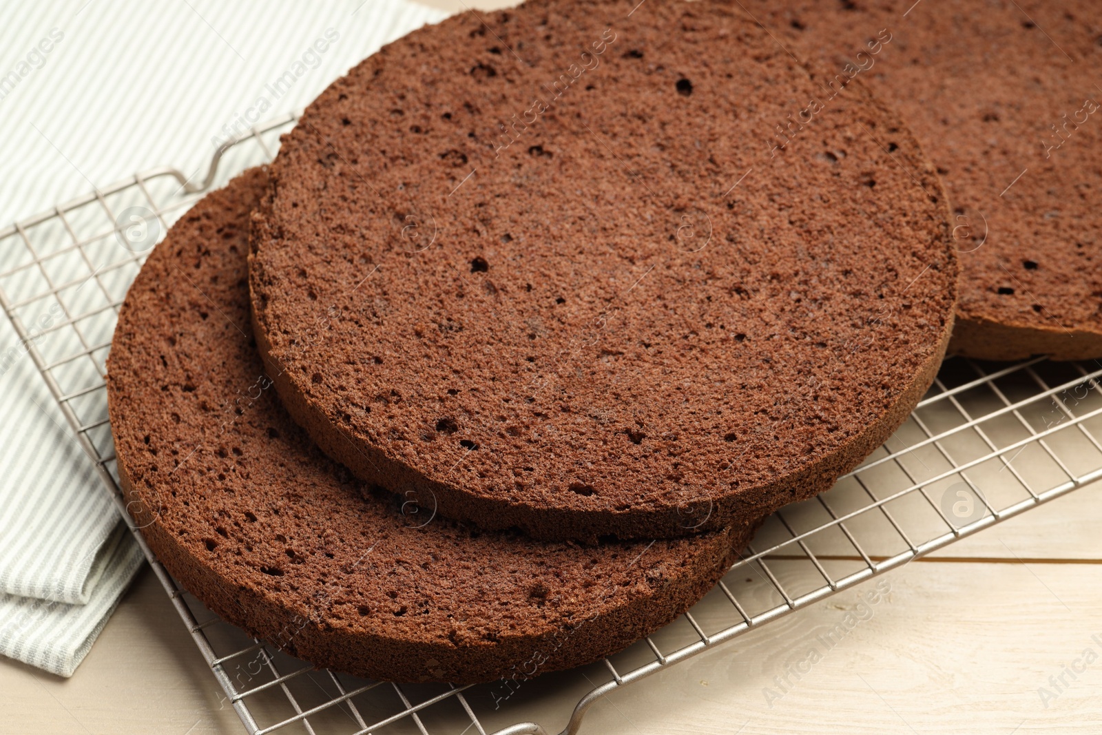 Photo of Cut tasty chocolate sponge cake on wooden table, closeup