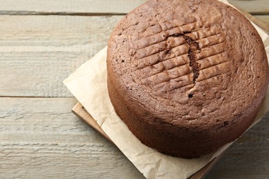 Photo of Tasty chocolate sponge cake on wooden table, closeup