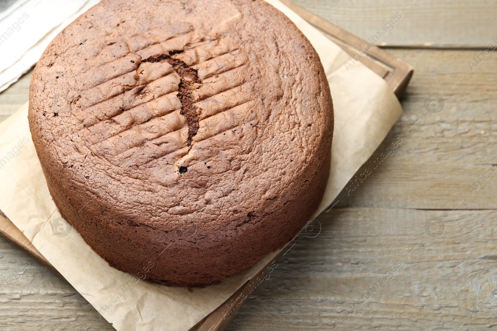 Photo of Tasty chocolate sponge cake on wooden table, closeup