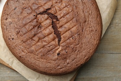 Photo of Tasty chocolate sponge cake on wooden table, top view