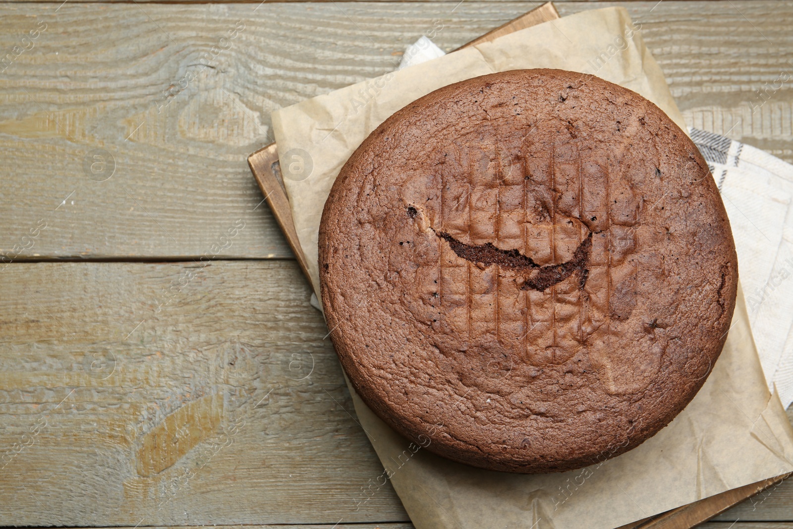 Photo of Tasty chocolate sponge cake on wooden table, top view. Space for text