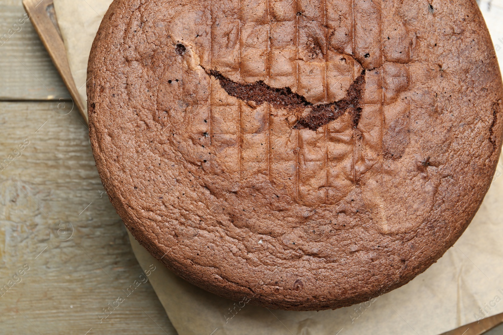 Photo of Tasty chocolate sponge cake on wooden table, top view