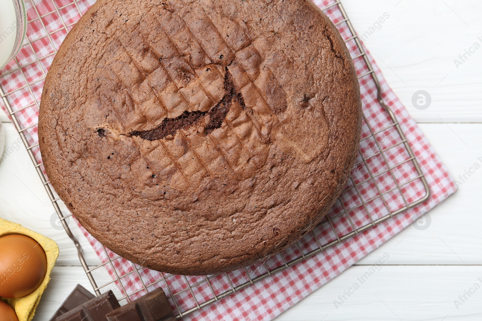 Photo of Tasty chocolate sponge cake on white wooden table, top view