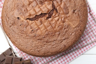 Photo of Tasty chocolate sponge cake on white wooden table, top view