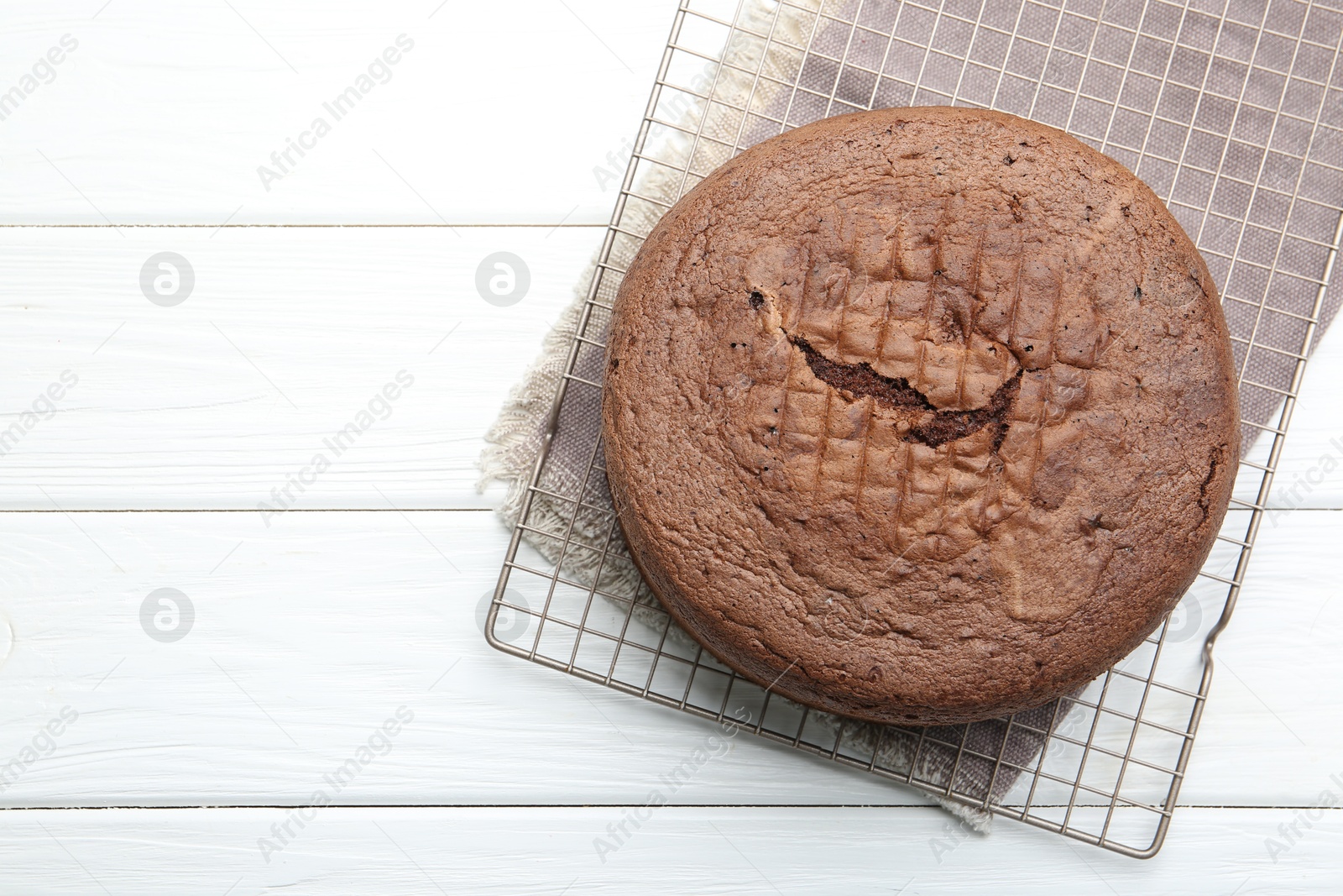 Photo of Tasty chocolate sponge cake on white wooden table, top view. Space for text