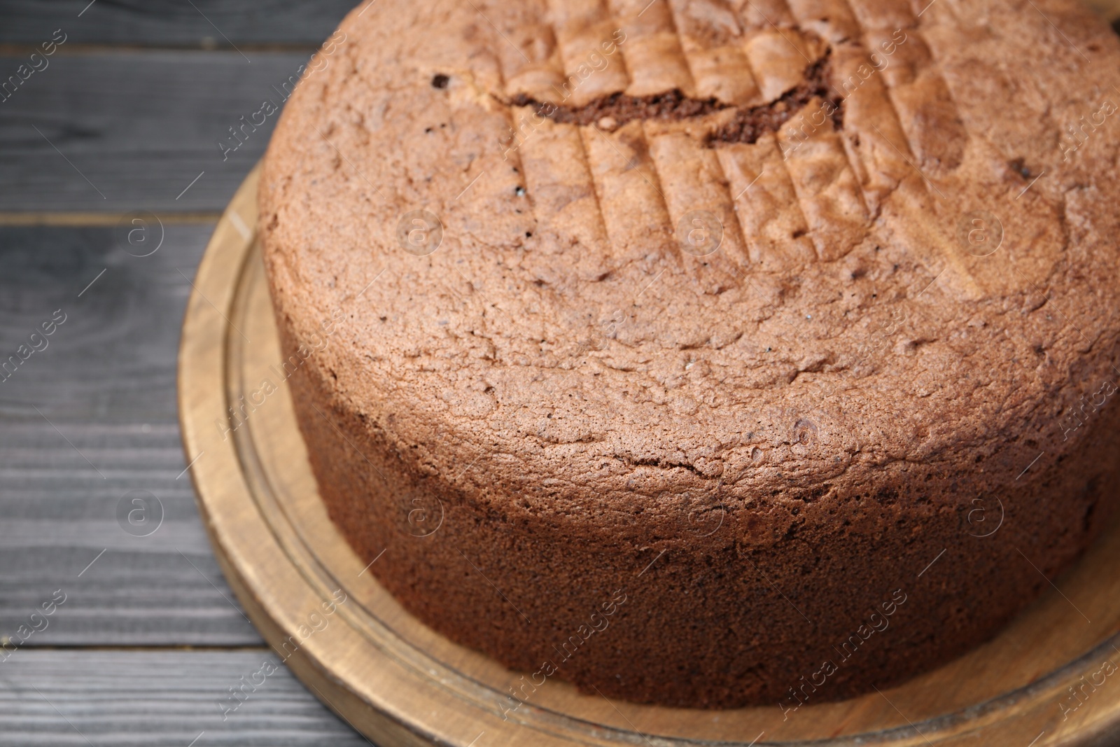 Photo of Tasty chocolate sponge cake on black wooden table, closeup