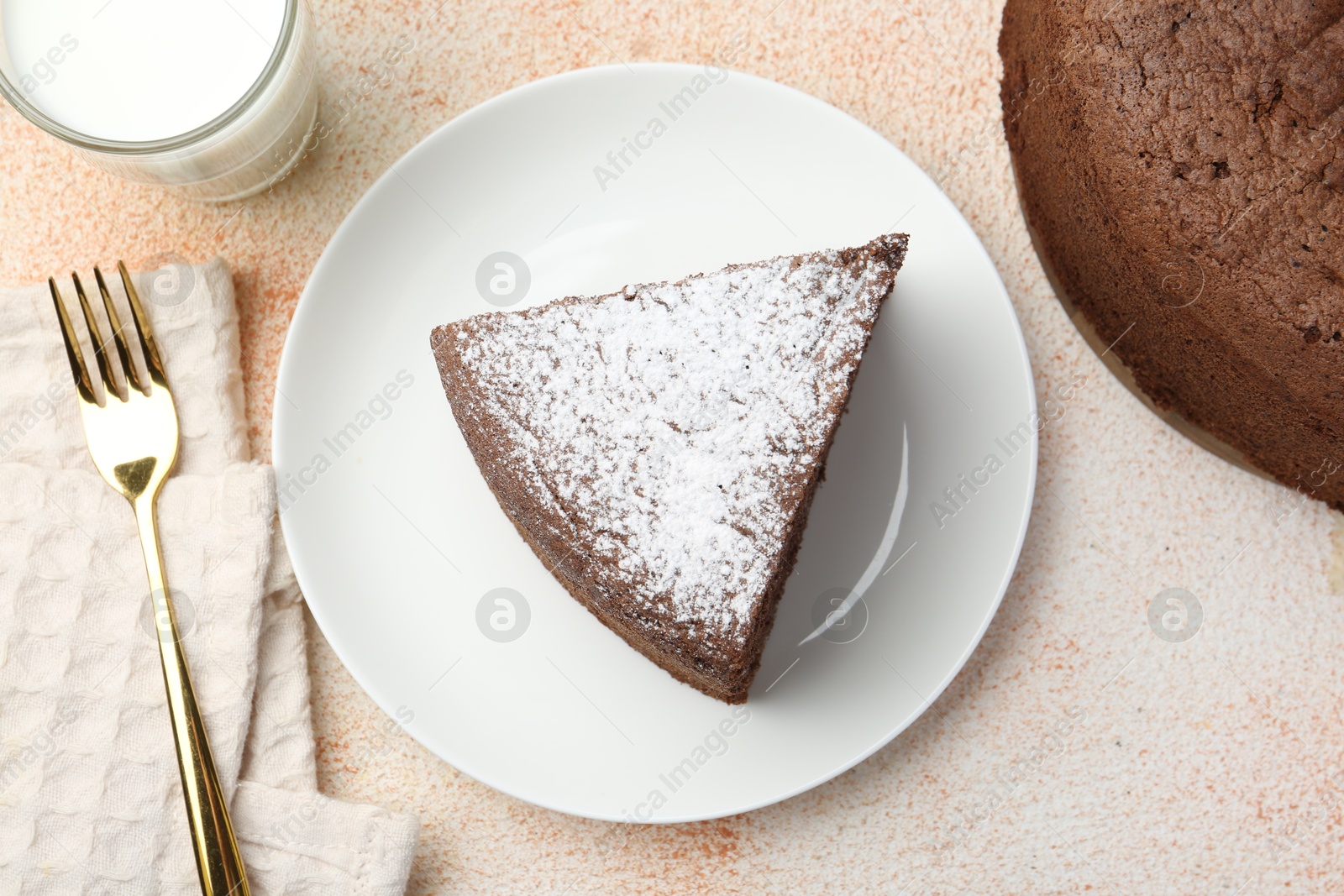 Photo of Piece of tasty chocolate sponge cake served on light table, flat lay