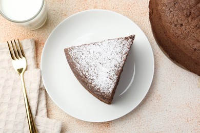 Photo of Piece of tasty chocolate sponge cake served on light table, flat lay